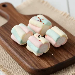 photograph of a rainbow marshmallow cube with sprinkles on a dark wooden chopping board, hessian cloth, styled food photography, photorealistic, 4 k