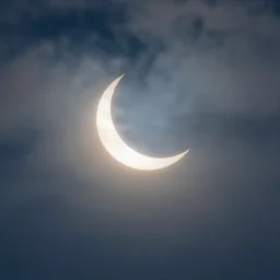 a crescent eclipse in a cloudy sky, a matte painting by sin wi, pixabay, neo - romanticism, chillwave, atmospheric, mystical