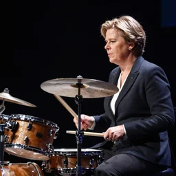 A photo of The Prime Minister of Sweden, Magdalena Andersson, playing a drums on stage. character photography, Exquisite detail, post-processing, moody light, bokeh, photorealistic. Photo by Stanley Kubrick