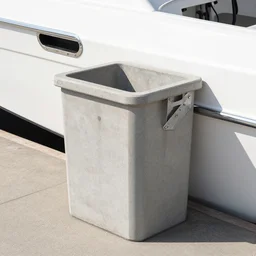 dry dock concrete clamshell grill garbage can on a shiny  chromeplated dented angular sharp vented motorboat hull,