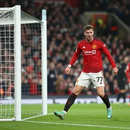 Roy Kent scoring a goal for for Manchester United, on the pitch