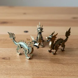 Little ornate windup toy metal dragons on a wooden tabletop