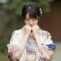 photo of Japanese woman wearing kimono with batik pattern, she is cute and shy