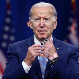 a photo of joe biden injecting himself with a needle, behind a stage