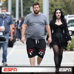 fat gamer adam sandler wearing gamer shorts and a goth gf walking in hollywood. espn coverage