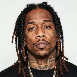 Alex Jones appears as Lil Wayne with dreadlocks and facial tattoos, close up, high quality, photo