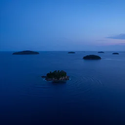 micro - hurricane, blue hour, early night, deep blue atmosphere, very late evening, sundown, scattered islands, sea, ocean, low pressure system, cloud with eye, very windy, late evening, distant hotel retreat on cliffside, shining lights on cliff side, polaroid photograph