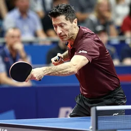 Robert Lewandowski playing table tennis on a tournament, table tennis racquet in his hand, high quality news photography