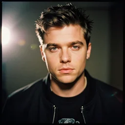 A Hyper realistic and detailed portrait photography by Annie Leibovitz of Martin Garrix. Agfa Vista 400 film. Detailed. Depth of field. lens flare. moody. cinematic. warm light. realistic. expired film.