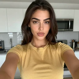 a selfie portrait a brunette female, young, athletic, australian, wearing a gold tshirt in a kitchen