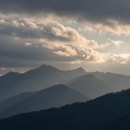 beautiful mountain range early in the morning with cumulus clouds