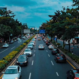 a road with many cars and people as a thermal image