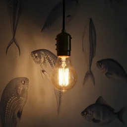 closeup design house mason pedant lamp with edison lightbulb hanging from wall with blowfish wall paper background, low light setting, dim lighting,
