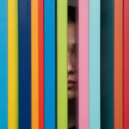 a face emerging from narrow colorful vertical bars