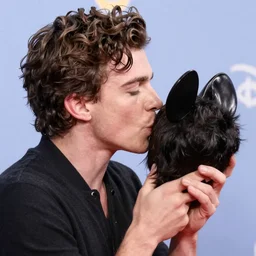 Tom holland kissing the top of Walt Disney’s head