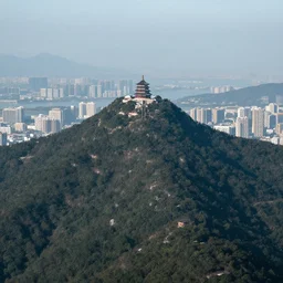 a city on top of a tall and skinny mountain