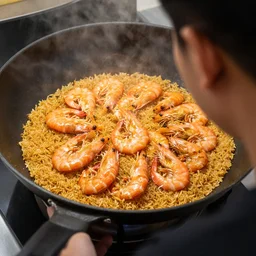 shrimps frying rice in a man