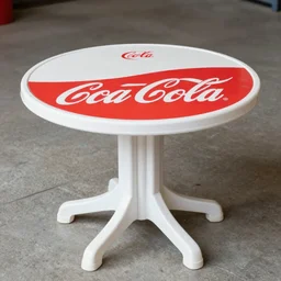 photograph of a plastic round table with coke branding,