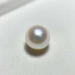 A shiny pearl is a small, round, lustrous object that is used as a gemstone