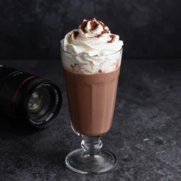 food photography of hot chocolate drink in tall glass with cream on top and cocoa powder, canon macro lens, moody lighting, stock images, front view
