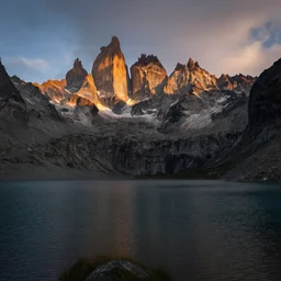 award winning landscape photography, lake in foreground with jagged highland mountains in background, beautiful morning light, dramatic lighting, ultra wide angle