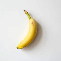 a banana taped to a white wall