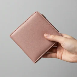 photo of hand with simple manicure holding wallet,