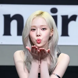 winter from aespa blowing a kiss to camera with the word noir written on a banner in background