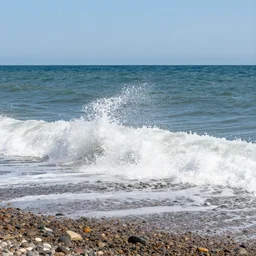 waves crashing in on a stony beach, realistic, hdr, clear image, hdd, dynamic lighting,