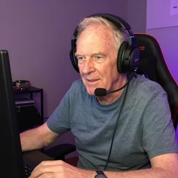 Jon Pertwee as a Twitch streamer, wearing a gaming headset, webcam screenshot