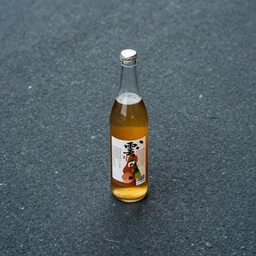 symmetrical photo of bottle standing on asphalte