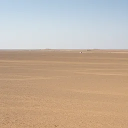 A vast, empty wasteland with a few scattered structures in the distance