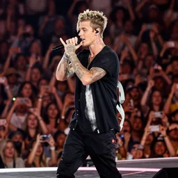 justin bieber performing for a crowd of justin biebers