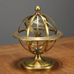 aphoto of an ancient, powerful brass and gold spherical astrolabe, sitting on a wooden table.