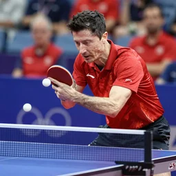 Robert Lewandowski playing table tennis on a tournament, high quality news photography