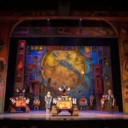 photo of a huge theaterstage, theaterplay is wall - e, 3 actors on stage, 8 k, multicolored, exaggerated detailed, long shot