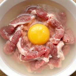 Raw beef mixed with raw pork in a soup with raw eggs