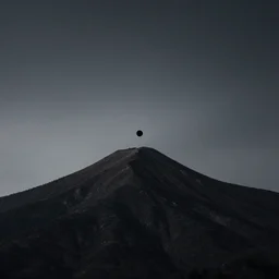 a black dot in the sky pulling in a mountain, dark lighting, landscape