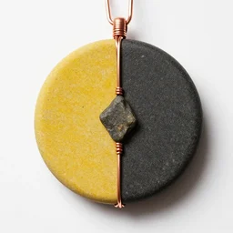 beautiful but simple circular amulet made from equal parts bright sandstone and dark sandstone with a small rock shard separating them in the middle, bound together by copper wire and representing powerful love