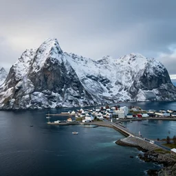 A coastal city near some snow-capped mountains, sci-fi, 8k photorealistic