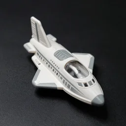 a toy space ship from the 8 0's. gray and white