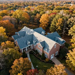 Luxurious low angle drone shot of a beautiful ranch style School campus in the middle of the Woods during autumn Epic photography