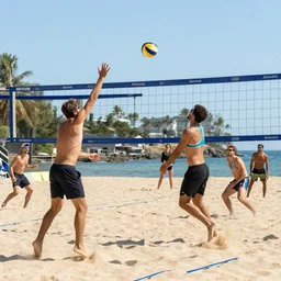 a group of friends playing beach volleyball