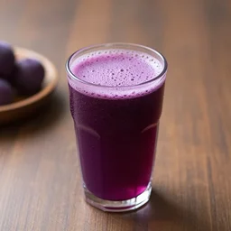 a cup of purple juice on a table