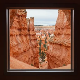 a view of a canyon through a window in a rock formation, a detailed matte painting by robert j. brawley, featured on unsplash, naturalism, bryce 3 d, windows vista, high dynamic range
