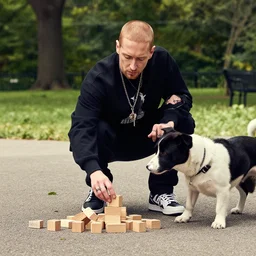 Eminem with a dog plays with wooden blocks at Central Park