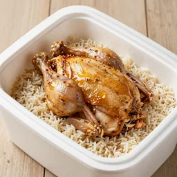 a Styrofoam container, full of bourbon, chicken and rice