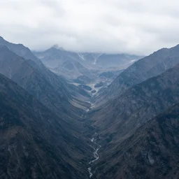 Panoramic photo where the mountains are towering over the valley below their peaks shrouded in mist. The sun is just peeking over the horizon and the sky is ablaze with colors. The river is winding its way through the valley and the trees are starting to turn yellow and red, by Greg Rutkowski