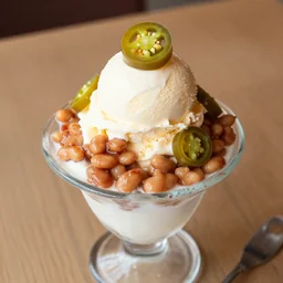 dslr food photograph of ice cream sundae with baked bean and sliced jalapeno topping, 8 5 mm f 1. 8