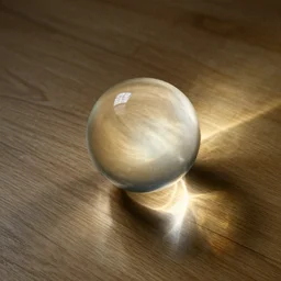 a glass ball on a wooden floor with light caustics.